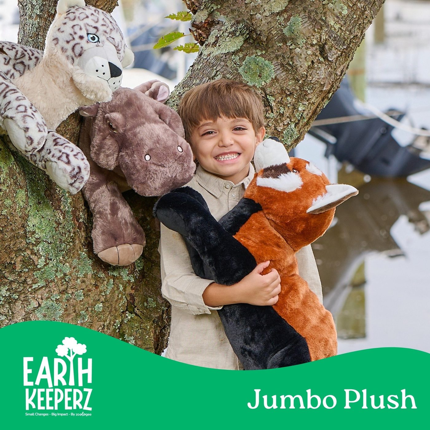A boy perched in a tree holding several Wild Onez plush animals