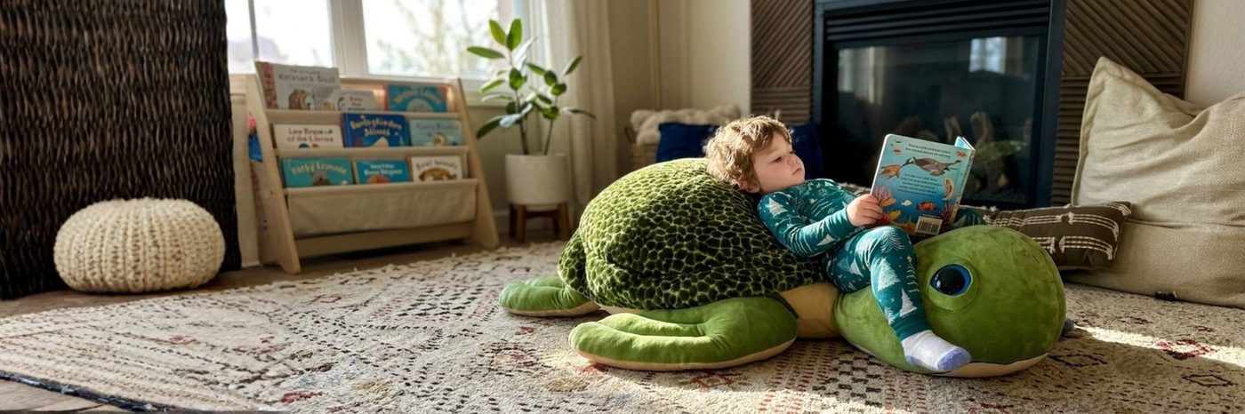 A green sea turtle jumbo plush stretched across a living-room rug